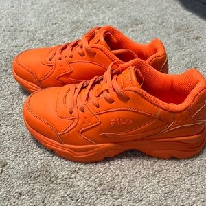 Little kid’s orange Fila sneakers